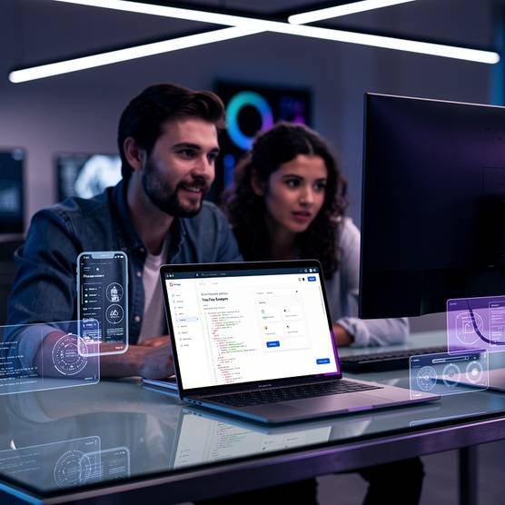 Modern digital agency workspace with laptop showing progressive web app design and team collaboration